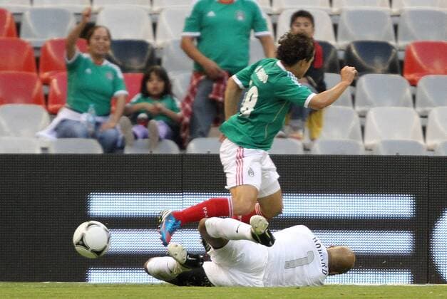 15 August 2012: Tim Howard (USA) (1) tackles the ball away from Andres Guardado (MEX) (18). The United States Men s National Team defeated the Mexico Men s National Team 1-0 at Estadio Azteca in Mexico City, Mexico in an international friendly soccer match. SOCCER: AUG 15 Mexico v USA Icon918120815016 EDITORIAL USE ONLY