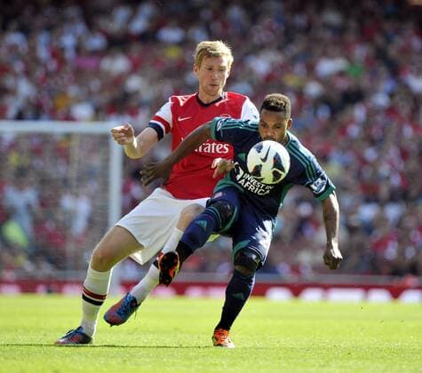 Football Premier League Arsenal Vs Sunderland Per Mertesacker and Stephane Sessegnon 