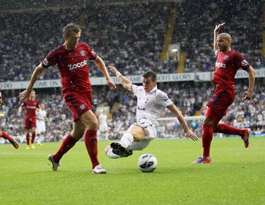 Tottenhams Gareth Bale goes in two footed on WBAs Claudio Yacob...Barclays Premier League, Tottenham Hotspur v West Bromwich Albion at White Hart Lane, London on the 25th August 2012. EDITORIAL USE ONLY. No use with unauthorised audio, video, data, fixture lists, club league logos or live services. Online in-match use limited to 120 images, no video emulation. No use in betting, games or single club league player publications.
