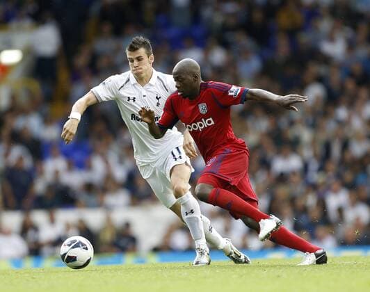 Tottenhams Gareth Bale tussles with WBAs Youssef Mulumbu...Barclays Premier League, Tottenham Hotspur v West Bromwich Albion at White Hart Lane, London on the 25th August 2012. EDITORIAL USE ONLY. No use with unauthorised audio, video, data, fixture lists, club league logos or live services. Online in-match use limited to 120 images, no video emulation. No use in betting, games or single club league player publications.