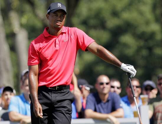 Tiger Woods reacts after his tee shot on the 12th hole in the final round of The Barclays 2012 FedExCup Playoffs at The Black Course at Bethpage State Park in Farmingdale, New York on August 26, 2012.  NYP20120826119