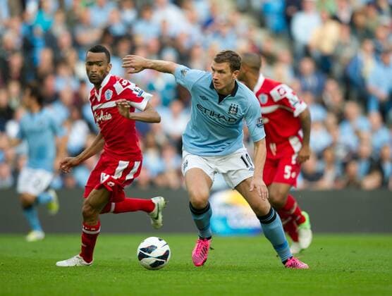 Football - Manchester City v Queens Park Rangers QPR - Barclays Premier League - The Etihad Stadium - Season 12 13 - 1 9 12 .Edin Dzeko of Manchester City turns Jose Bosingwa of Queens Park Rangers QPR. EDITORIAL USE ONLY. No use with unauthorised audio, video, data, fixture lists, club league logos or live services. Online in-match use limited to 120 images, no video emulation. No use in betting, games or single club league player publications.