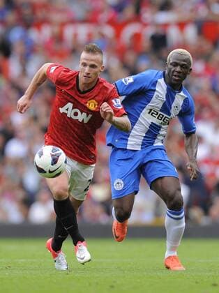 Alexander Buttner of Manchester United tussles with Arouna Kone of Wigan Athletic.Football - Manchester Utd v Wigan Athletic - Barclays Premier League - Old Trafford Stadium - Season 12 13 - 15 9 12 .Mandatory Credit: Simon Bellis Sportimage.. EDITORIAL USE ONLY. No use with unauthorised audio, video, data, fixture lists, club league logos or live services. Online in-match use limited to 120 images, no video emulation. No use in betting, games or single club league player publications.