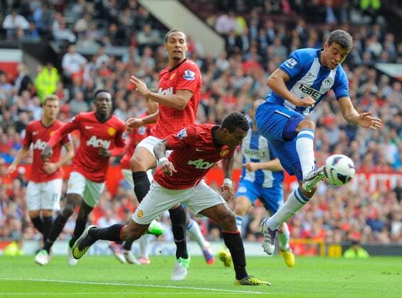 Franco Di Santo of Wigan Athletic challenges for the ball with Nani of Manchester United.Football - Manchester Utd v Wigan Athletic - Barclays Premier League - Old Trafford Stadium - Season 12 13 - 15 9 12. EDITORIAL USE ONLY. No use with unauthorised audio, video, data, fixture lists, club league logos or live services. Online in-match use limited to 120 images, no video emulation. No use in betting, games or single club league player publications.