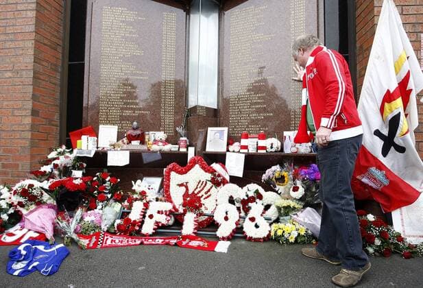 Football - Premier league- Liverpool v Manchester United-A fan pays his respects at the Hillsborough memorial at Anfield 