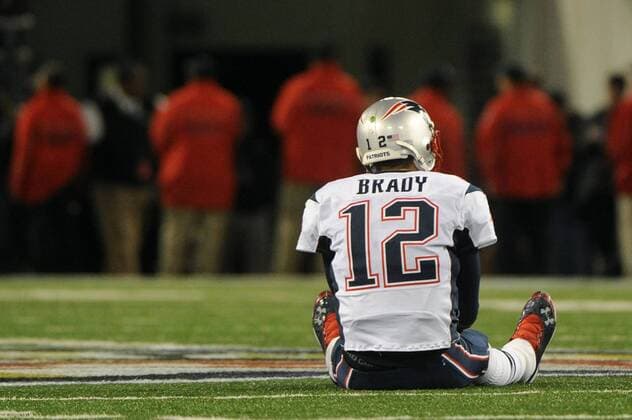 New England Patriots quarterback Tom Brady sits on the field after going three-and-out in the fourth quarter against the Baltimore Ravens at M&T Bank Stadium in Baltimore, Maryland on September 23, 2012. Ravens defeated the Patriots 31-30.  WAP20120923318