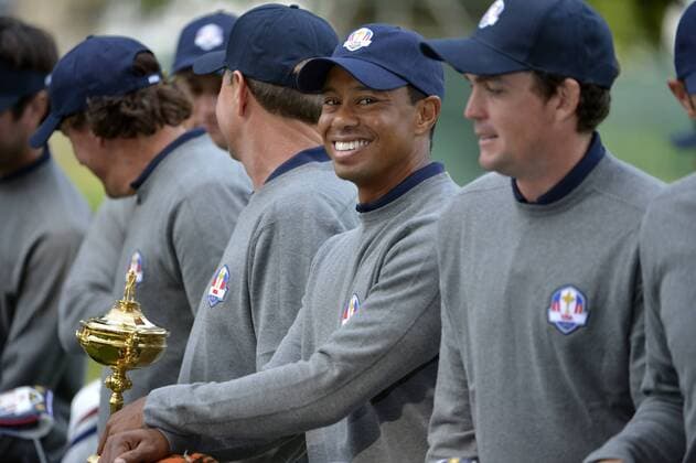 Tiger Woods smiles as he poses with other United States Ryder Cup teammates at the 39th Ryder Cup at Medinah Country Club on Tuesday, September 25, 2012 in Medinah, Illinois. Ryder Cup tournament play begins Friday.  BKX2012092542