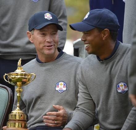 United States Ryder Cup team captain Davis Love III (L) talks with Tiger Woods while they wait for a team photo at the 39th Ryder Cup at Medinah Country Club on Tuesday, September 25, 2012 in Medinah, Illinois. Ryder Cup tournament play begins Friday.  BKX2012092539
