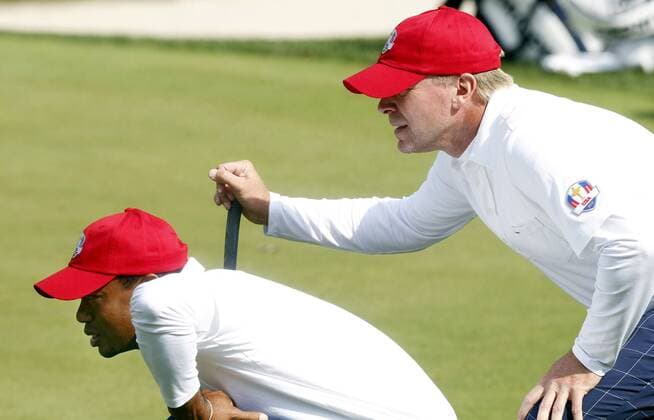 Team USA s Tiger Woods, left, and Steve Stricker, right, line up a putt on the 14th green at the 39th Ryder Cup at Medinah Country Club on September 28, 2012 in Medinah, Illinois.  MED2012092803