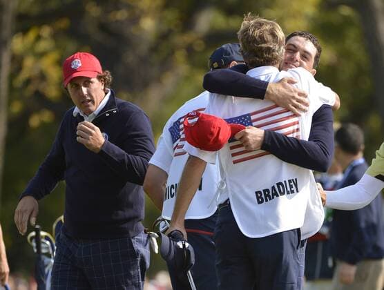 Team USA s Keegan Bradley (R) hugs his caddie Steve Hale after sinking a birdie putt to win his match on the 15th hole at the 39th Ryder Cup at Medinah Country Club on September 28, 2012 in Medinah, Illinois.  BKX2012092845