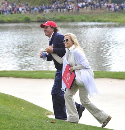 Team USA s Phil Mickelson (L) and his wife Amy follow teammates Jim Furyk and Brandt Snedeker on the 17th green at the 39th Ryder Cup at Medinah Country Club on September 28, 2012 in Medinah, Illinois.  BKX2012092846
