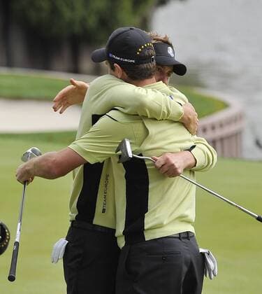 Team Europe s Ian Poulter of England (L) hugs teammate Justin Rose of England after the pair won their match against Team USA s Tiger Woods and Steve Stricker at the 39th Ryder Cup at Medinah Country Club on September 28, 2012 in Medinah, Illinois.  BKX2012092859