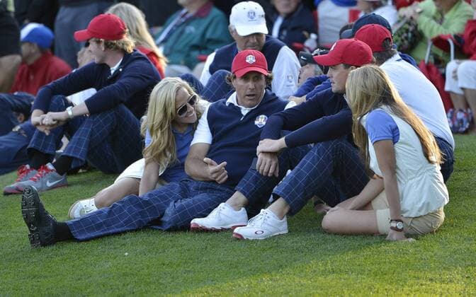Team USA s Phil Mickelson and his wife Amy (L) talk with Keegan Bradley and his girlfriend Jillian Stacey as they watch other matches on the 16th green at the 39th Ryder Cup at Medinah Country Club on September 28, 2012 in Medinah, Illinois. After the first day of play the United States leads Europe 5-3.  BKX2012092883
