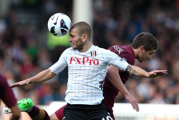 Football - Premier League - Fulham FC vs Manchester City Fulham s Mladen Petric heads the ball at Craven Cottage, London, England 