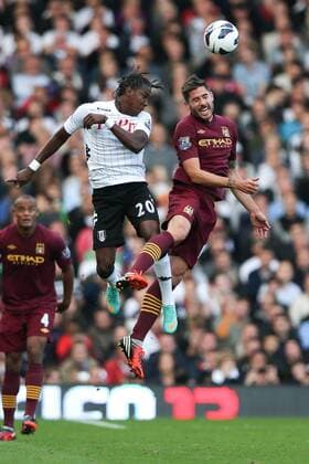 Football - Premier League - Fulham FC vs Manchester City Manchester City s Javi Garcia and Fulham s Hugo Rodallega go up for the ball at Craven Cottage, London, England 