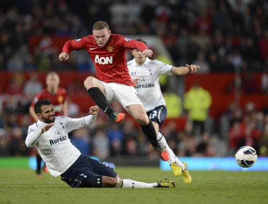 Wayne Rooney of Manchester United is tackled by Sandro of Tottenham -Barclays Premier League - Manchester United (ManU) vs Tottenham Hotspur - Old Trafford Stadium - Manchester - 29 09 12 - EDITORIAL USE ONLY. No use with unauthorised audio, video, data, fixture lists, club league logos or live services. Online in-match use limited to 120 images, no video emulation. No use in betting, games or single club league player publications.