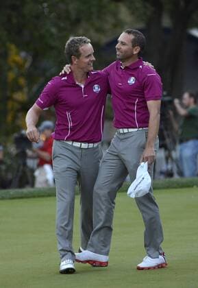 Team Europe s Luke Donald of England (L) hugs teammate Sergio Garcia of Spain after the pair defeated Team USA s Tiger Woods and Steve Stricker on the 18th hole at the 39th Ryder Cup at Medinah Country Club on September 29, 2012 in Medinah, Illinois. After the second day of play the United States leads Europe 10-6 and needs 4 1 2 points in the final round to win the Ryder Cup.  BKX2012092971