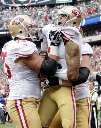 San Francisco 49ERS Colin Kaepernick and Alex Boone react after Kaepernick runs the ball in the endzone 7 yards for a touchdown in the second quarter against the New York Jets in week 4 of the NFL American Football Herren USA season at MetLife Stadium in East Rutherford, New Jersey on September 30, 2012. UPI John Angelillo  NYP20120930117