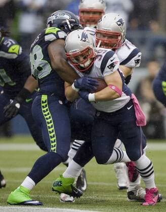 New England Patriots running back Danny Woodhead (39) is held up by Seattle Seahawks at CenturyLink Field in Seattle, Washington on October 14, 2012. With 1:18 remaining the Seahawks rallied for 14 points to stun the New England Patriots 24 -23.  SEA2012101409