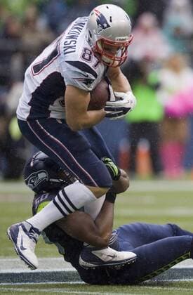 Seattle Seahawks linebacker K.J. Wright tackles New England Patriots tight end Rob Gronkowski at CenturyLink Field in Seattle, Washington on October 14, 2012. With 1:18 remaining the Seahawks rallied for 14 points to stun the New England Patriots 24-23.  SEA2012101412
