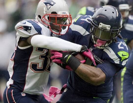 Seattle Seahawks running back Marshawn Lynch is tackled by New England Patriots Alfonzo Dennard at CenturyLink Field in Seattle, Washington on October 14, 2012. With 1:18 remaining the Seahawks rallied for 14 points to stun the New England Patriots 24-23.  SEA2012101425