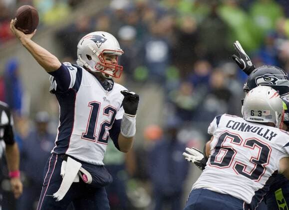 New England Patriots quarterback Tom Brady passes against the Seattle Seahawks at CenturyLink Field in Seattle, Washington on October 14, 2012. With 1:18 remaining the Seahawks rallied for 14 points to stun the New England Patriots 24-23. Brady completed 36 of 58 passes for 395 yards and two touchdowns and had two interceptions.  SEA2012101432