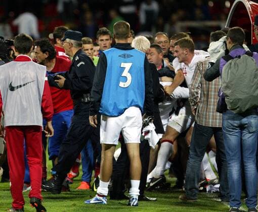 16.10.2012 Krusevac(Serbia) Serbia-England UEFA Under 21 Euro qualify play off men s football Fighting beside exit tunnel Tom Lees(2nd from right with number 14) England,Serbian policeman(3rd from left) and Dejan Govedairca(2nd from left) Serbia assistant coach 