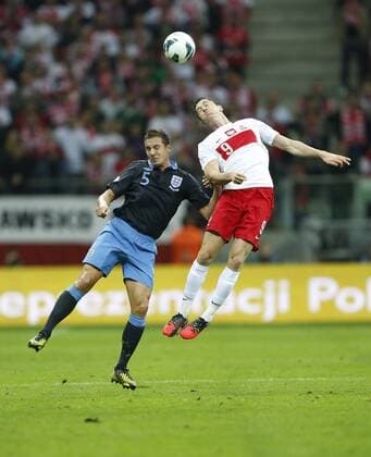 Poland s Robert Lewandowski tussles with England s Phil Jagielka..Poland v England - FIFA World Cup Qualifier - National Stadium, Warsaw Stadium- 17 10 12 - Picture David Klein Sportimage EDITORIAL USE ONLY. No use with unauthorised audio, video, data, fixture lists, club league logos or live services. Online in-match use limited to 120 images, no video emulation. No use in betting, games or single club league player publications.