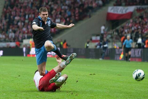 World Cup Qualifier -- Poland vs. England -- Marcin Wasilewski of Poland challenges James Milner of England at the National Stadium, Warsaw 