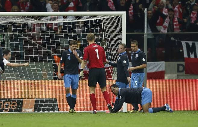 England s players look at Joe Hart after Poland s equaliser..Poland v England - FIFA World Cup Qualifier - National Stadium, Warsaw Stadium- 17 10 12 - Picture David Klein Sportimage EDITORIAL USE ONLY. No use with unauthorised audio, video, data, fixture lists, club league logos or live services. Online in-match use limited to 120 images, no video emulation. No use in betting, games or single club league player publications.