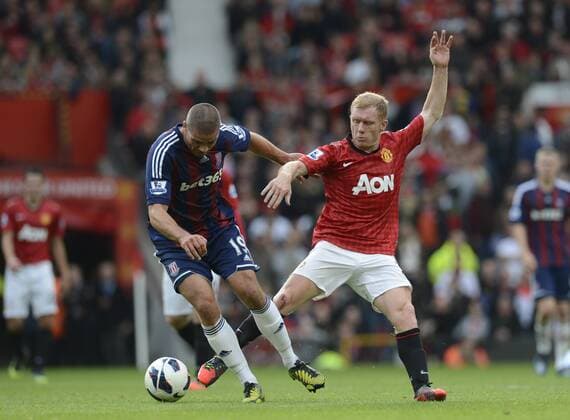 Paul Scholes of Manchester United tackles Jonathan Walters of Stoke City - Barclays Premier League - Manchester United (ManU) vs Stoke City - Old Trafford Stadium - Manchester - 20 10 12 - EDITORIAL USE ONLY. No use with unauthorised audio, video, data, fixture lists, club league logos or live services. Online in-match use limited to 120 images, no video emulation. No use in betting, games or single club league player publications.