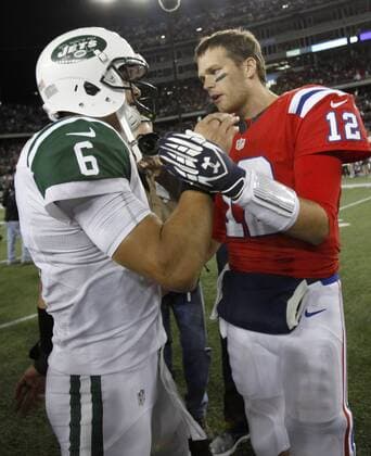 New England Patriots quarterback Tom Brady (12) and New York Jets quarterback Mark Sanchez (6) shake hands after the Patriots defeated the New York Jets 29-26 in overtime at Gillette Stadium in Foxboro, Massachusetts on October 21, 2012.  BOS2012102108