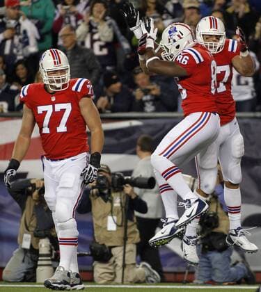 New England Patriots tight ends Daniel Fells (87) and Rob Gronkowski (87) celebrate a two yard touchdown reception by Gronkowski as teammate offensive lineman Nate Solder (77) looks on in the third quarter against the New York Jets at Gillette Stadium in Foxboro, Massachusetts on October 21, 2012. The Patriots defeated the Jets 29-26 in overtime.  BOS2012102111