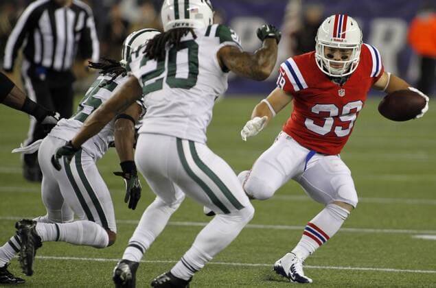 New England Patriots running back Danny Woodhead (39) charges towards New York Jets cornerback Isaiah Trufant (35) and Kyle Wilson (20) on a carry for a loss of two yards in the fourth quarter at Gillette Stadium in Foxboro, Massachusetts on October 21, 2012. The Patriots defeated the Jets 29-26 in overtime.  BOS2012102112