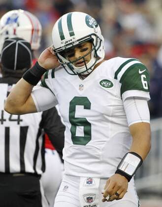 New York Jets quarterback Mark Sanchez pulls at his helmet straps after being called for a penalty for kicking the ball out of the end zone in the second quarter against the New England Patriots at Gillette Stadium in Foxboro, Massachusetts on October 21, 2012. The Patriots defeated the Jets 29-26 in overtime.  BOS2012102115
