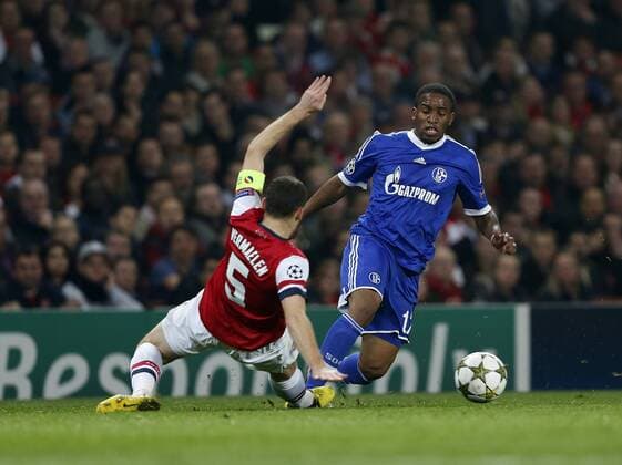 Arsenal s Thomas Vermaelen tussles with Schalke s Jefferson Farfan..Arsenal London vs FC Schalke 04 - Champions League Group Match - The Emirates Stadium, London- 24 10 12 - EDITORIAL USE ONLY. No use with unauthorised audio, video, data, fixture lists, club league logos or live services. Online in-match use limited to 120 images, no video emulation. No use in betting, games or single club league player publications.