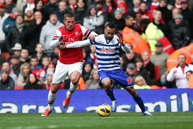 Football - Premier League - Arsenal FC vs Queens Park Rangers Arsenal s Lukas Podolski and QPR S Jose Bosingwa in action at the Emirates Stadium, London 