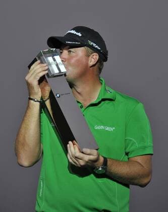Peter Hanson of Sweden kisses his champion trophy during the award ceremony of the BMW Masters golf tournament at the Lake Malaren Golf Club in Shanghai, China, 28 October 2012.  20121028_35393