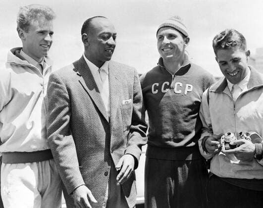 Melbourne. Australia. The 16th Summer Olympic Games. American track and field athlete Jesse Owens (L second) talking with participants of the Olympic Games.  TASS_1483812