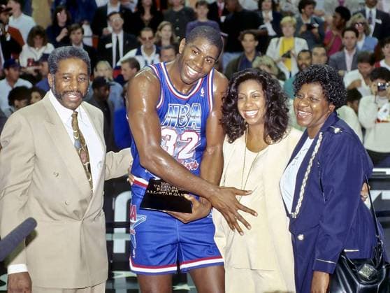 Feb. 9, 1992 - Miami, Florida, U.S. - Los Angeles Lakers EARVIN MAGIC JOHNSON awarded 1992 NBA Basketball Herren USA All-Star game MVP trophy, with pregnant wife and mother NBA Basketball Herren USA 1992 - Magic Johnson 1992 NBA Basketball Herren USA All-Star Game  - ZUMAl10