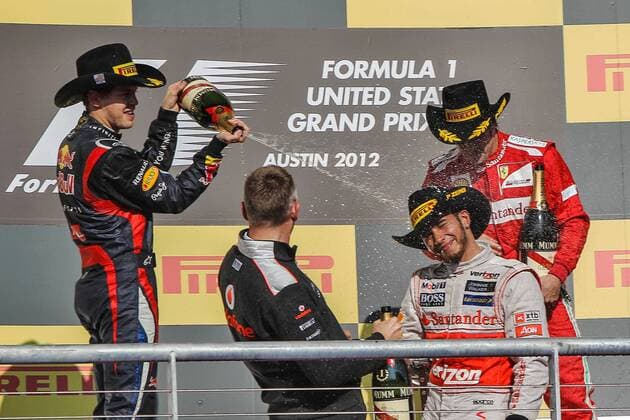 Nov. 18, 2012 - Sebastian Vettel (1) driver of the Red Bull Racing Renault sparys Lewis Hamilton (4) driver of the Vodafone McLaren Mercedes with champagne after during the Formula 1 United States Grand Prix race at the Circuit of the Americas race track in Austin,Texas. F1 2012 - United States Grand Prix - Hamilton wins... - ZUMAw30