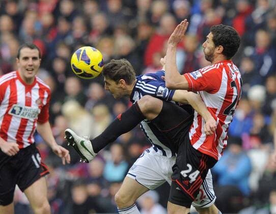 West Brom s Zoltan Gera (L) beats Carlos Cuellar of Sunderland to the ball - Barclays Premier League - AFC Sunderland vs West Bromwich Albion - Stadium of Light - AFC Sunderland - 24 11 12 EDITORIAL USE ONLY. No use with unauthorised audio, video, data, fixture lists, club league logos or live services. Online in-match use limited to 120 images, no video emulation. No use in betting, games or single club league player publications.