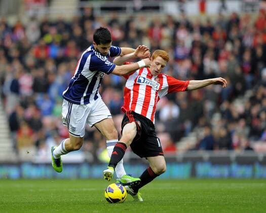West Brom s Shane Long (L) is challenged by Jack Colback of Sunderland - Barclays Premier League - AFC Sunderland vs West Bromwich Albion - Stadium of Light - AFC Sunderland - 24 11 12 EDITORIAL USE ONLY. No use with unauthorised audio, video, data, fixture lists, club league logos or live services. Online in-match use limited to 120 images, no video emulation. No use in betting, games or single club league player publications.