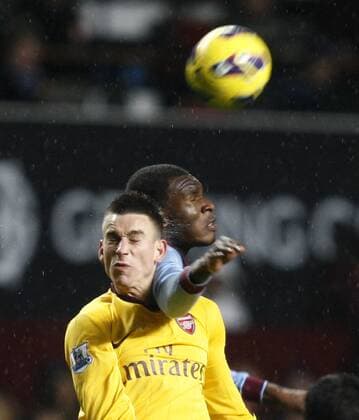 Football -Premiership - Aston Villa vs FC Arsenal London- Aston Villa s Christian Benteke and Arsenal s Laurent Koscielny battle for the ball at Villa Park. 