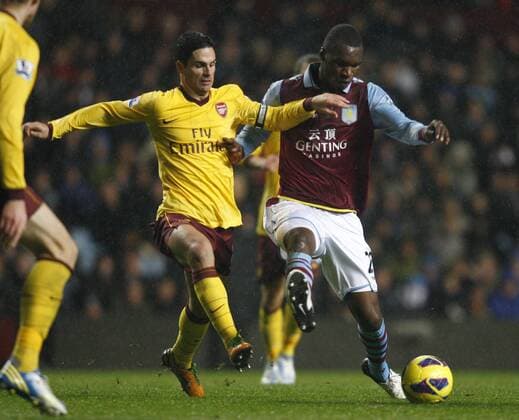 Football -Premiership - Aston Villa vs FC Arsenal London-Aston Villa s Christian Benteke and Arsenal s Mikel Arteta battle for the ball at Villa Park. 