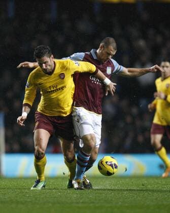 Football -Premiership - Aston Villa vs FC Arsenal London-Arsenal s Olivier Giroud and Aston Villa s Ron Vlaar battle for the ball at Villa Park. 