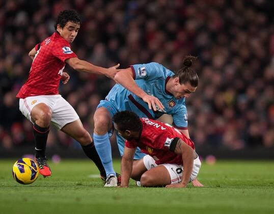 Football - 2012 2013 Premier League - Manchester United vs. West Ham United Rafael and Anderson of Manchester United get to grips with Andy Carroll of West Ham at Old Trafford 