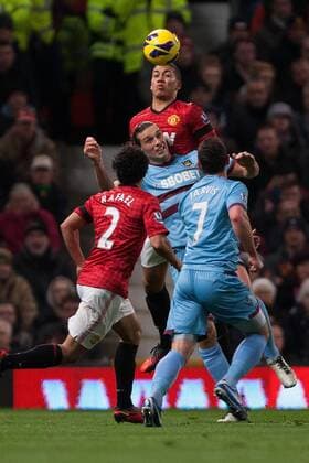 Football - 2012 2013 Premier League - Manchester United vs. West Ham United Chris Smalling of Manchester United defends against Andy Carroll of West Ham at Old Trafford 