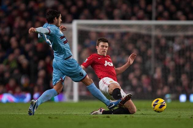 Football - 2012 2013 Premier League - Manchester United vs. West Ham United Michael Carrick of Manchester United goes in with a challenge on West Ham s James Tomkins at Old Trafford 