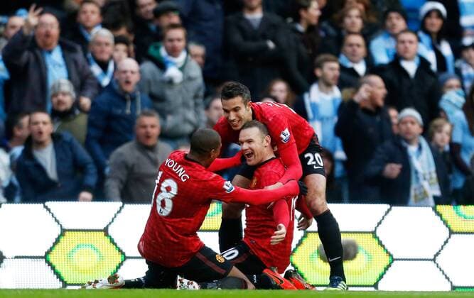 Wayne Rooney (R) of Manchester United celebrates after scoring the opening goal with team mates Robin van Persie and Ashley Young (L) - Barclays Premier League - Manchester City v Manchester United - Etihad Stadium - Manchester - England - 12th December 2012 EDITORIAL USE ONLY. No use with unauthorised audio, video, data, fixture lists, club league logos or live services. Online in-match use limited to 120 images, no video emulation. No use in betting, games or single club league player publications.